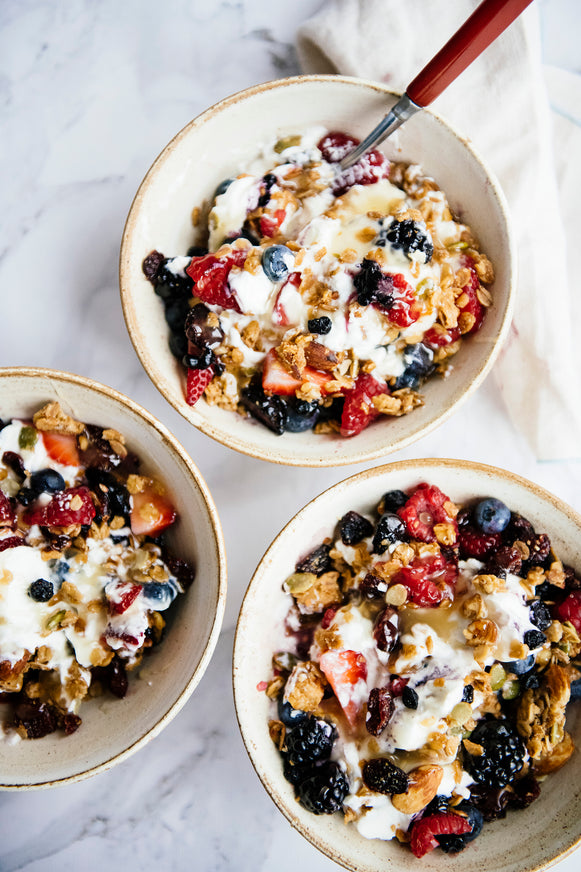 Bowls of yogurt, granola and fresh fruit