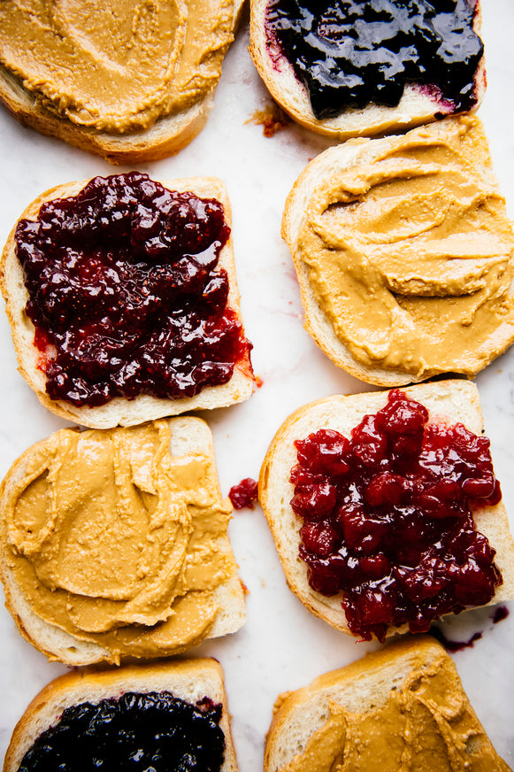 Pieces of toast with jam and peanut butter