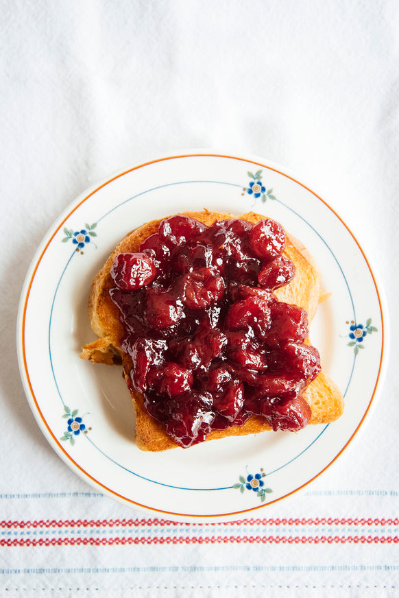 Cherry preserves spread on toast.