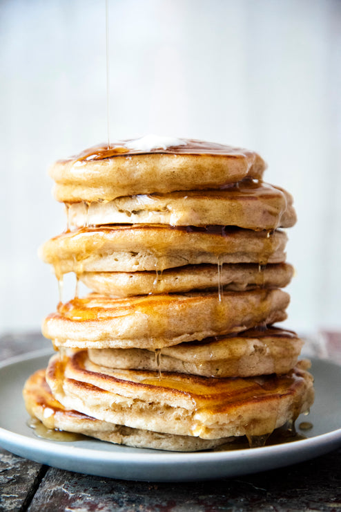 Load image into Gallery viewer, A stack of pancakes drizzled with Maple Syrup
