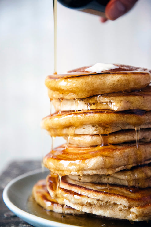 Load image into Gallery viewer, Stack of pancakes with Maple Syrup poured over
