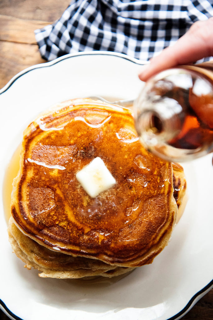 a stack of pancakes topped with maple syrup