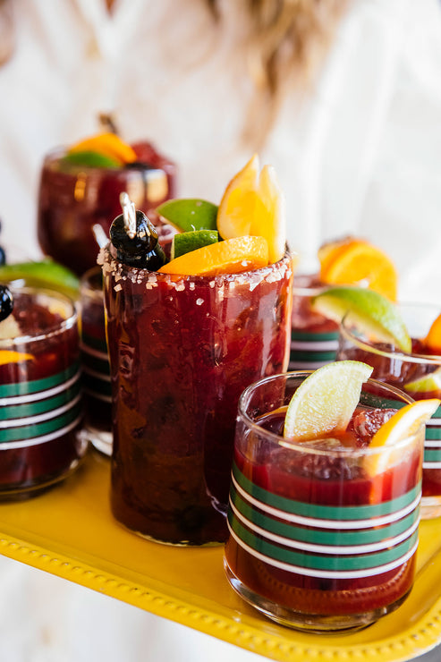 Load image into Gallery viewer, Tray of glasses containing a cocktail made with Cherry Margarita Mix and fresh fruit
