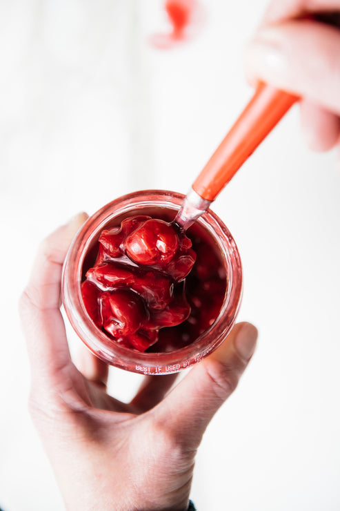 Load image into Gallery viewer, Spooning from an open jar of Fruit Perfect Sour Cherries
