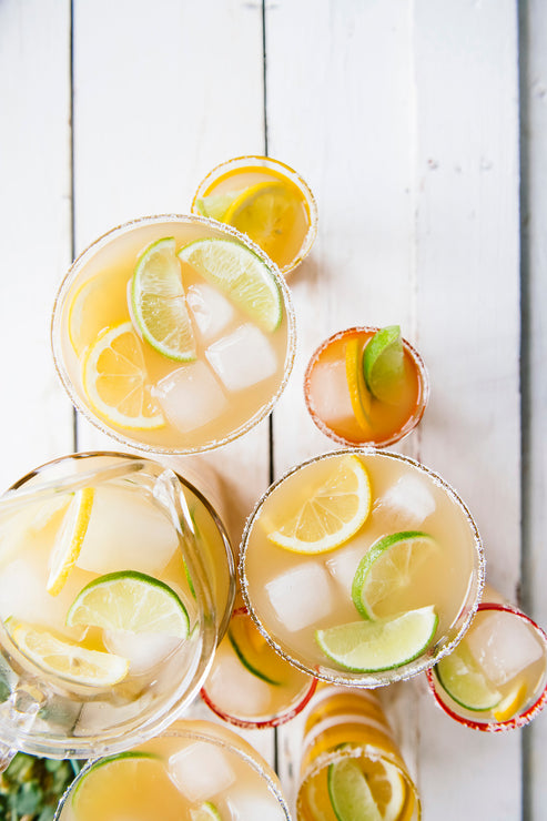 Load image into Gallery viewer, Margaritas garnished with lemons and limes.
