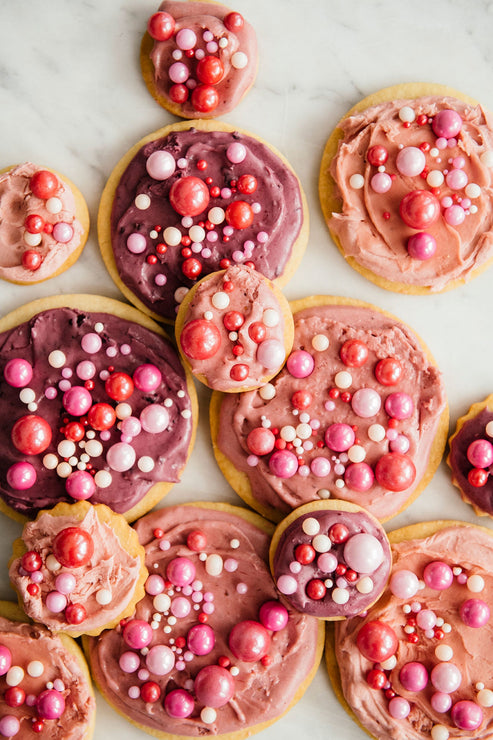 Load image into Gallery viewer, holiday cookies decorated with pink jam frosting
