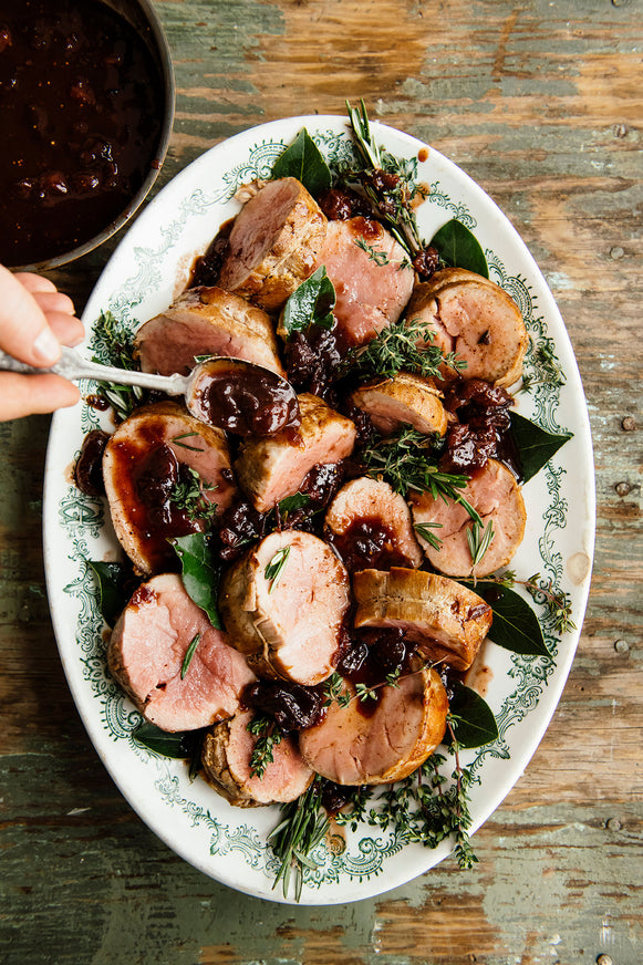 Roast pork with holiday jam pan sauce on a vintage platter.