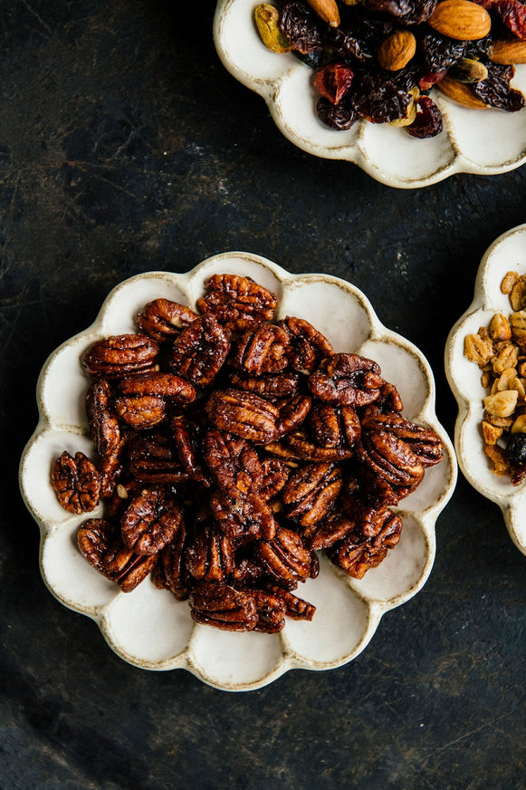 a round plate of candied pecans