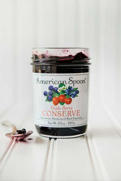 Load image into Gallery viewer, Open jar of Triple Berry Conserve with the preserve on a spoon
