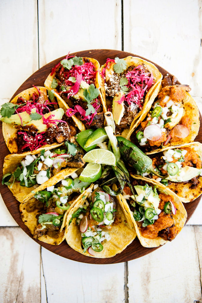 Platter of chicken and steak tacos, topped with American Spoon salsa and fresh lime