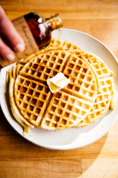 Load image into Gallery viewer, waffles topped with butter and maple syrup
