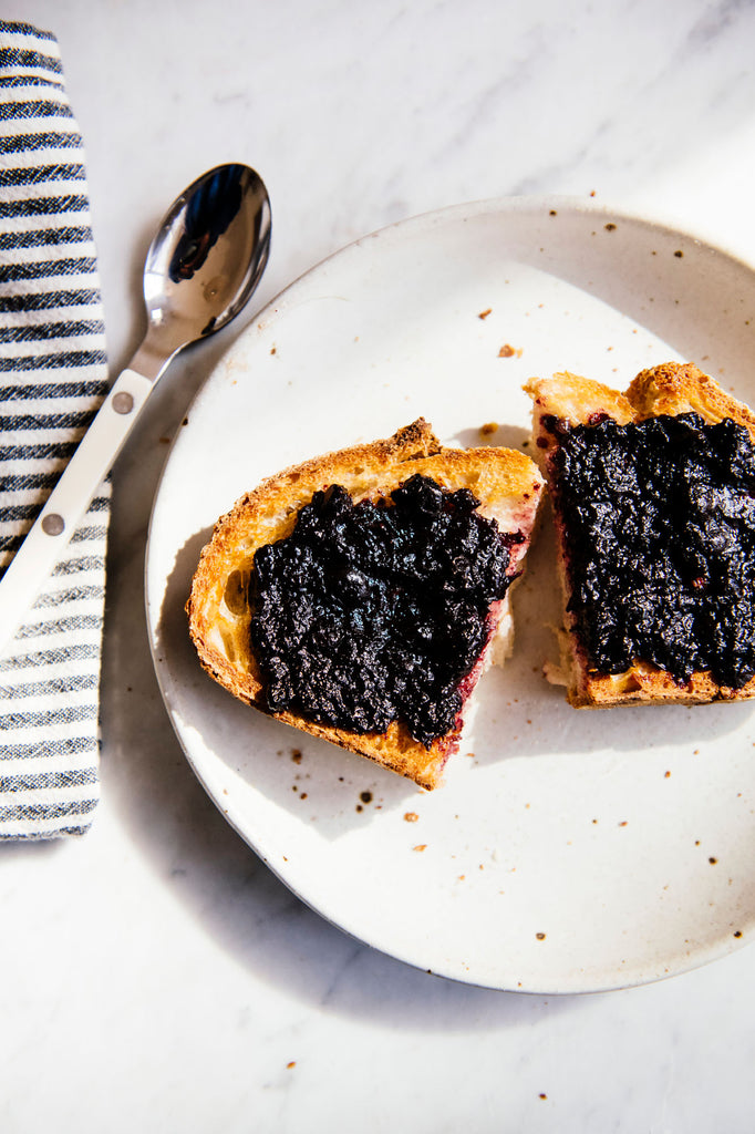a slice of toast topped with blueberry preserves
