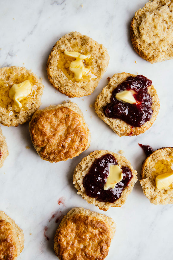 Homemade biscuits with preserves and slabs of melting butter