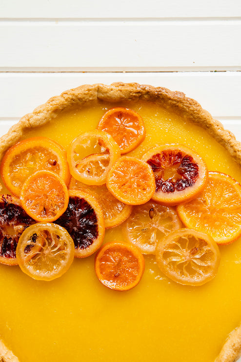 Load image into Gallery viewer, a yellow lemon tart with slices of fresh citrus

