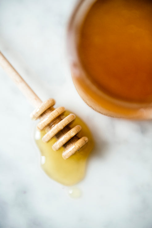 Load image into Gallery viewer, honey dripping off a wooden honey dipper
