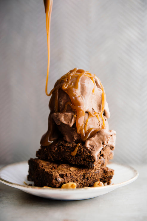 Load image into Gallery viewer, Brownies with chocolate ice cream and a drizzle of butterscotch.

