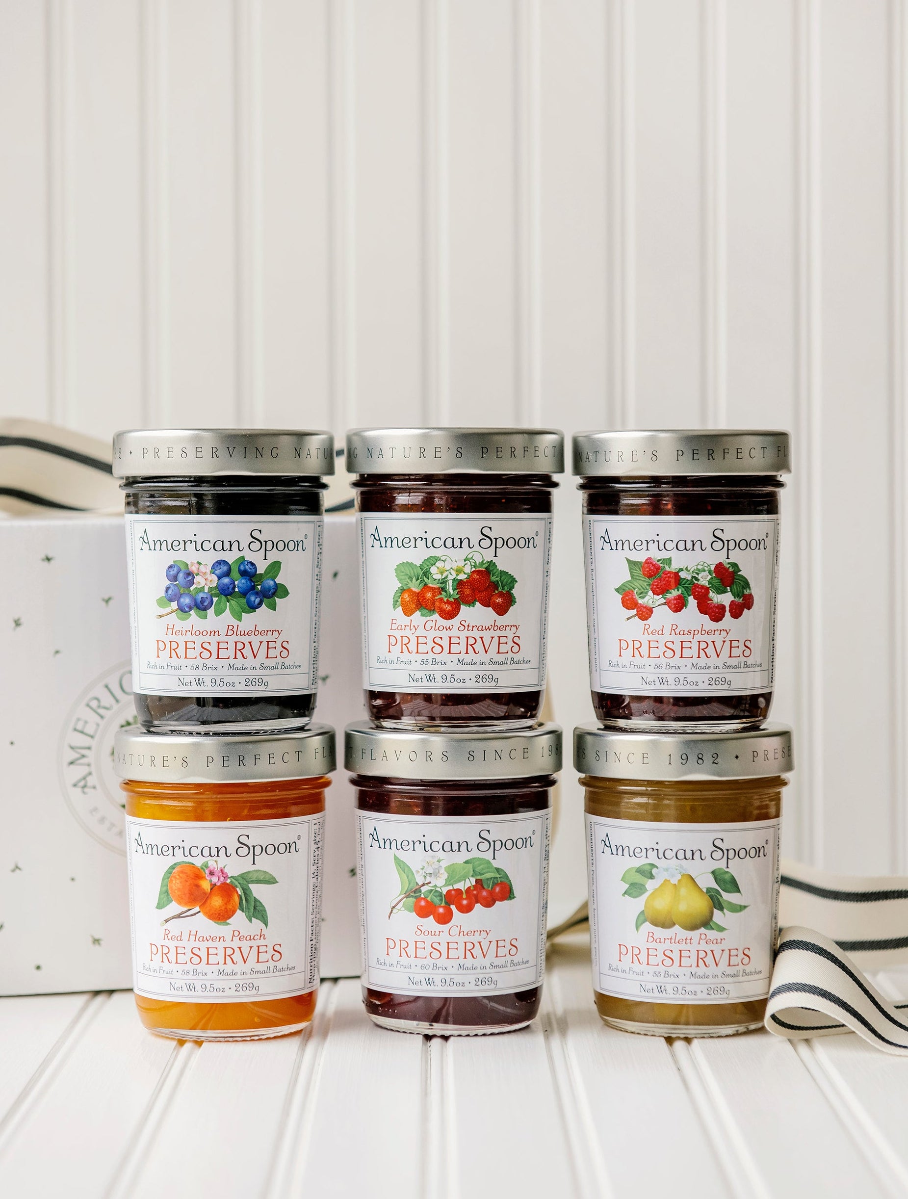 The Michigan Six Pack gift box containing Heirloom Blueberry Preserves, Early Glow Strawberry Preserves, Red Raspberry Preserves, Red Haven Peach Preserves, Sour Cherry Preserves and Bartlett Pear Preserves