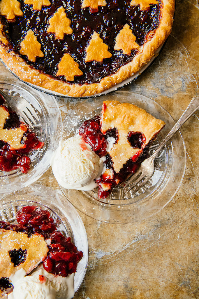 slices of cherry pie with a side of vanilla ice cream