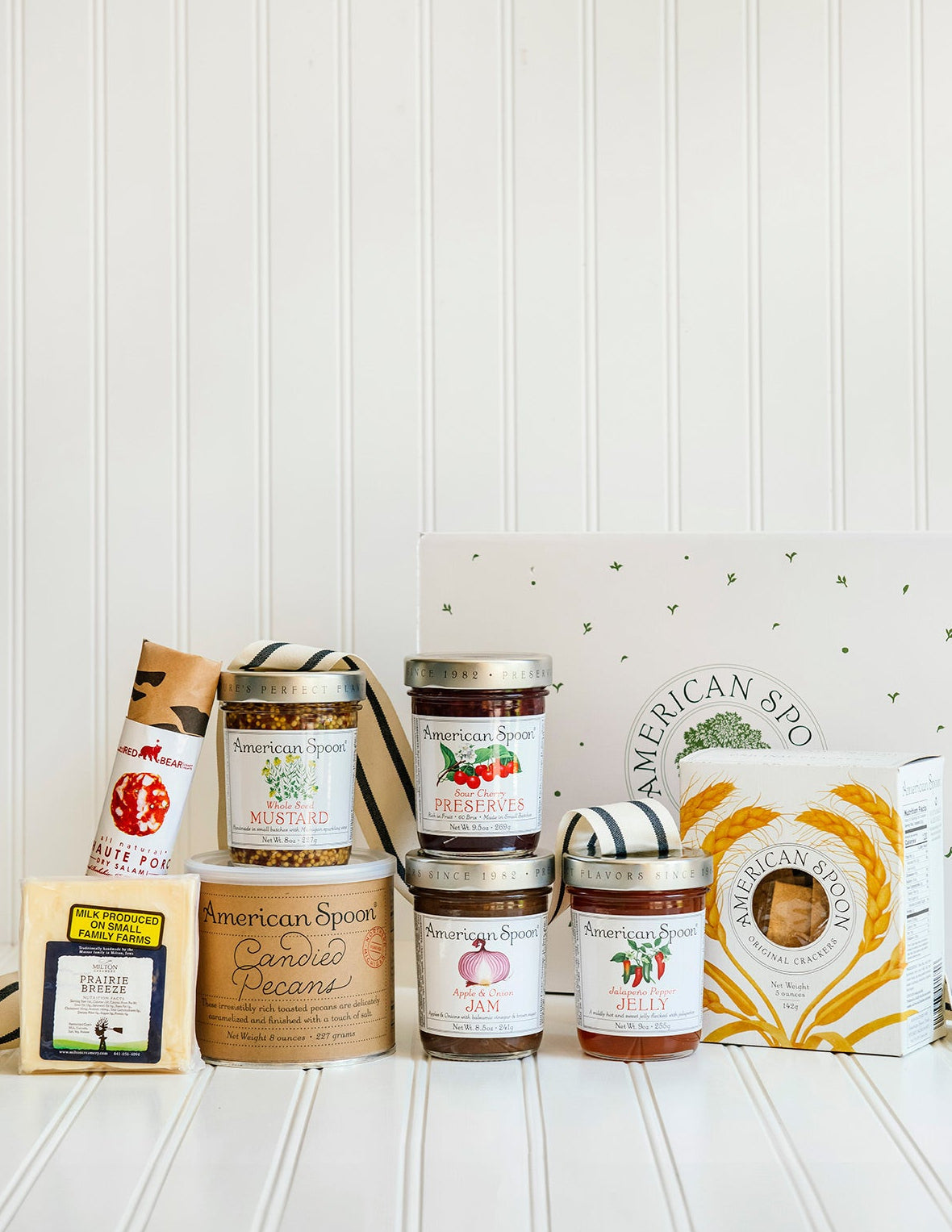 The Entertainer gift including Haute Porc Salami, Prairie Breeze Cheese, Whole Seed Mustard, 8 oz Candied Pecans, Sour Cherry Preserves, Apple & Onion Jam, Jalapeno Pepper Jelly, American Spoon Original Crackers and a gift box