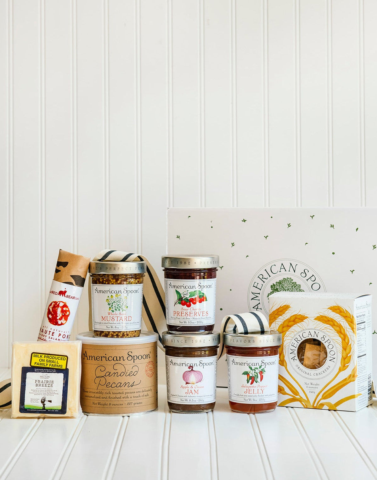 The Entertainer gift including Haute Porc Salami, Prairie Breeze Cheese, Whole Seed Mustard, 8 oz Candied Pecans, Sour Cherry Preserves, Apple & Onion Jam, Jalapeno Pepper Jelly, American Spoon Original Crackers and a gift box