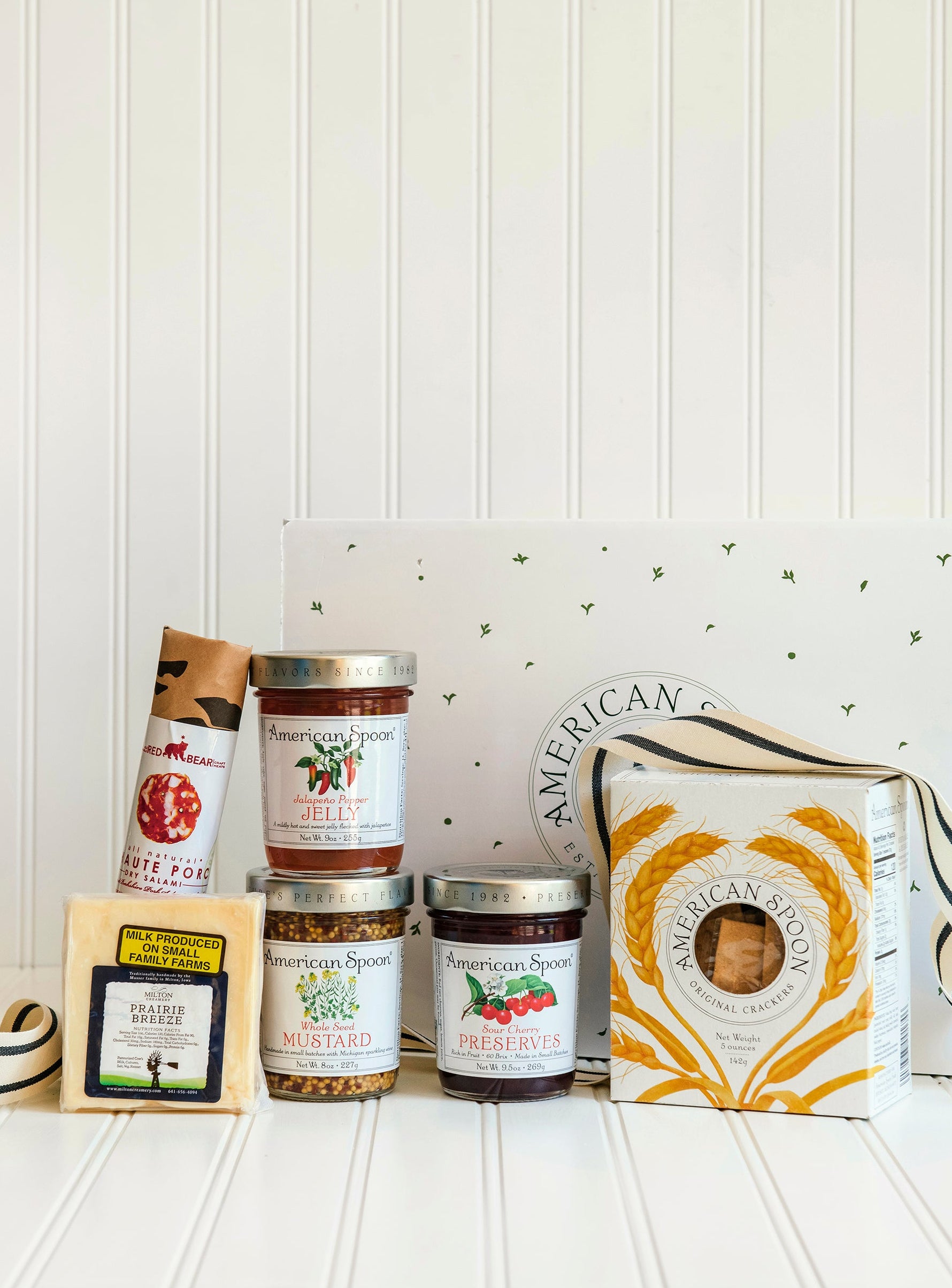 The Party Starter gift box including Haute Porc Salami, Prairie Breeze Cheese, Jalapeno Pepper Jelly, Whole Seed Mustard, Sour Cherry Preserves, American Spoon Original Crackers and a gift box