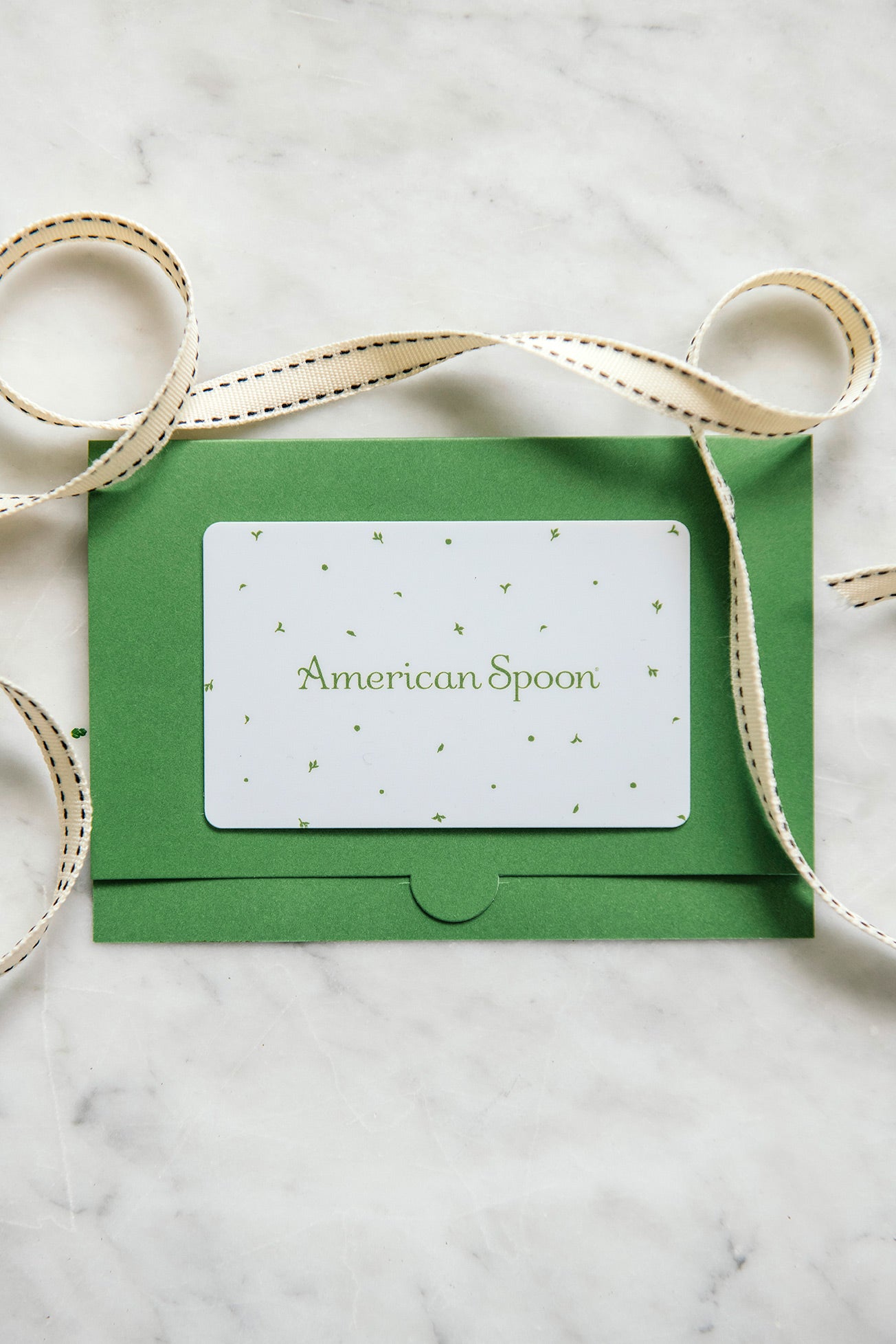 american spoon gift card in a holder surrounded by ribbon
