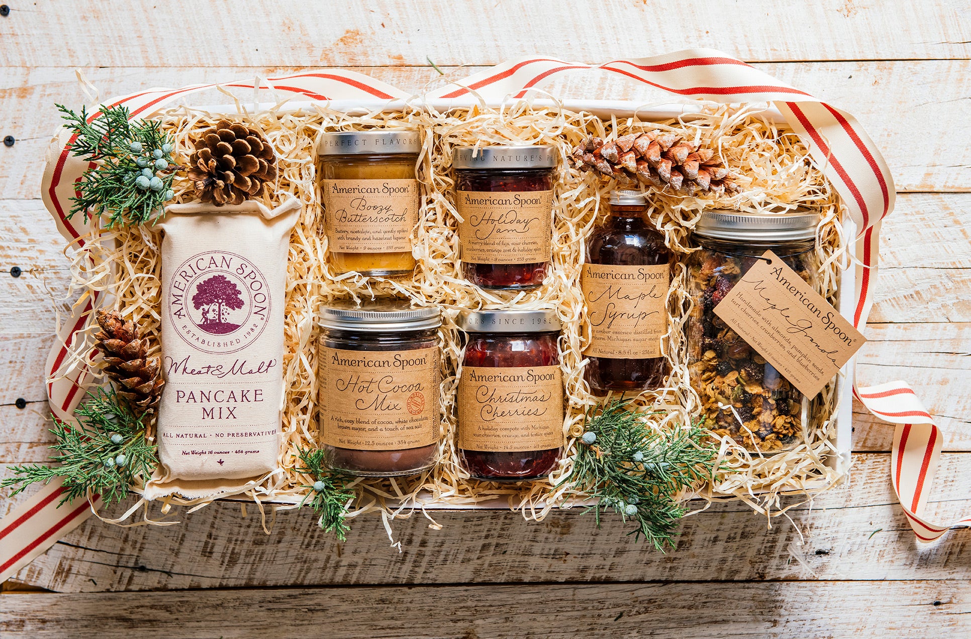The Christmas Cheer gift box including maple syrup, Christmas cherries, boozy butterscotch, hot cocoa mix, holiday jam, maple granola and wheat & malt pancake mix