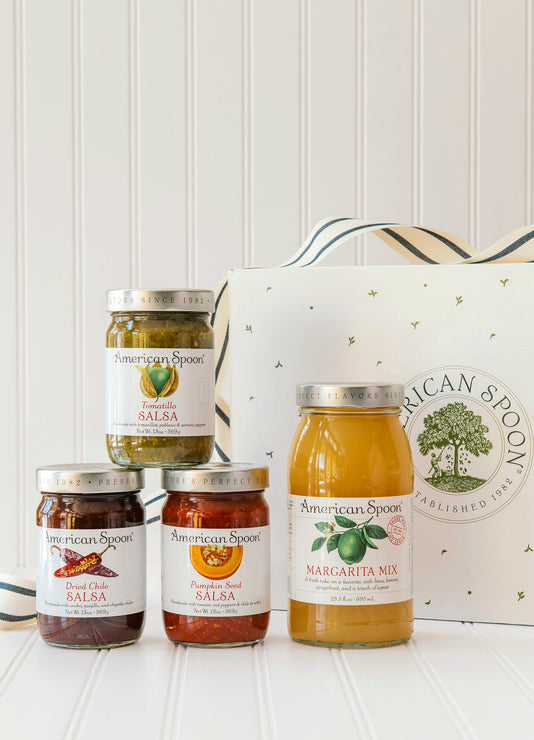 Load image into Gallery viewer, American Spoon Tomatillo, Dried Chili &amp; Pumpkin Seed salsa and Margarita mix bottles with a branded box on a white surface.
