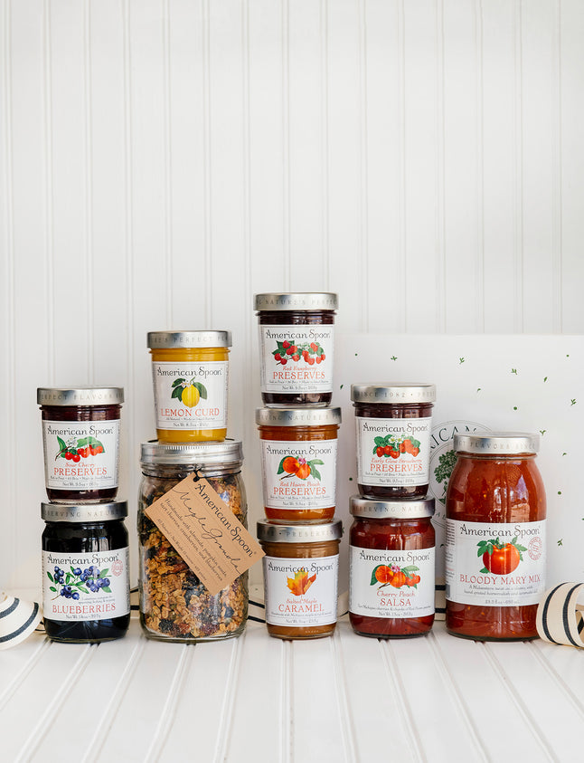 A collection of American Spoon bestsellers: Fruit Perfect Blueberries, Sour Cherry Preserves, Lemon Curd, Maple Granola, Red Raspberry Preserves, Red Haven Peach Preserves, Salted Maple Caramel, Early Glow Strawberry Preserves, Cherry-Peach Salsa, and Bloody Mary Mix
