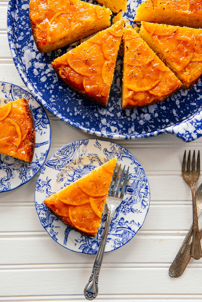 sliced orange marmalade cake on blue floral plates