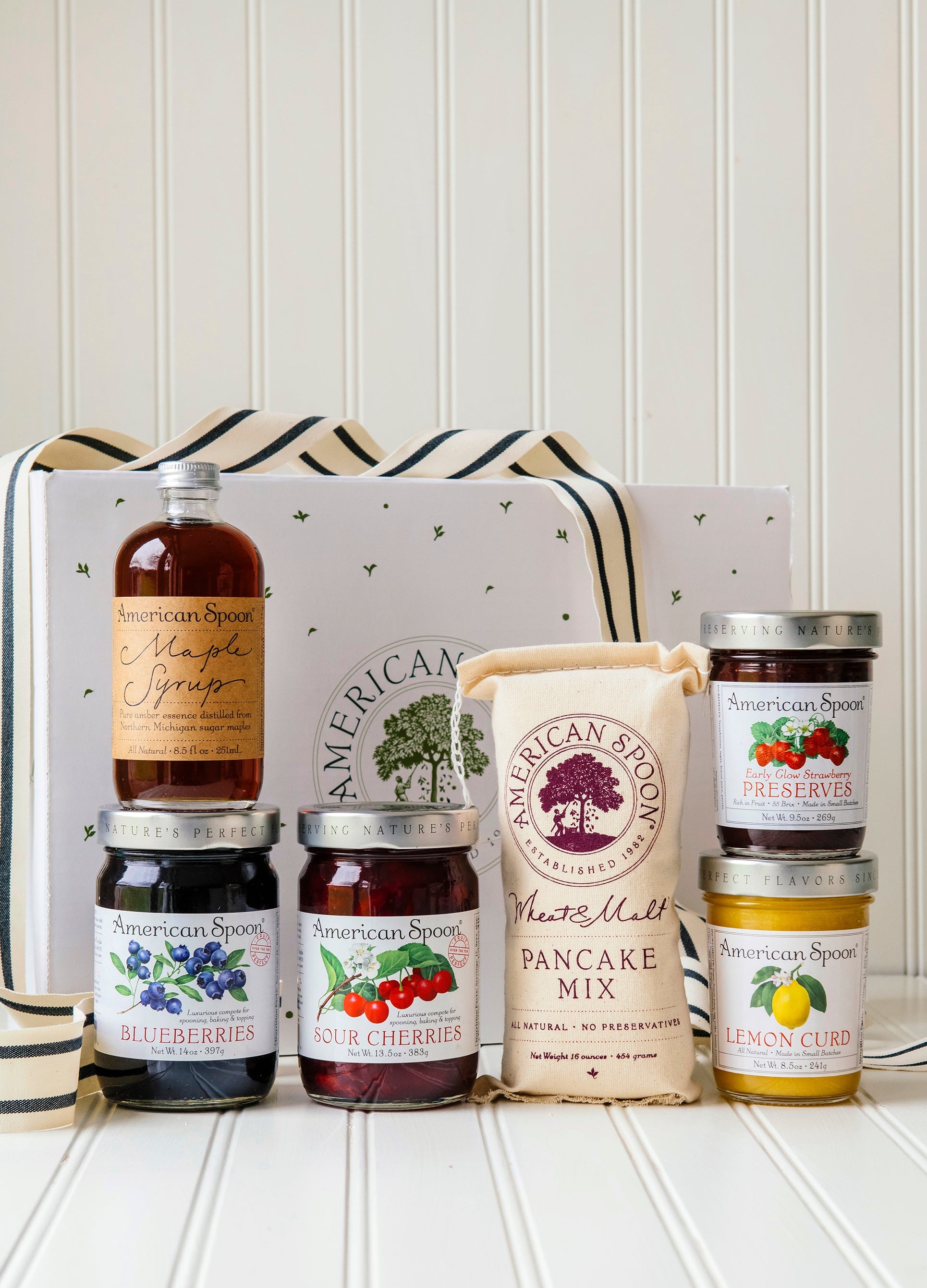 The Up North Breakfast gift box including Maple Syrup, Fruit Perfect Blueberries, Fruit Perfect Sour Cherries, Wheat & Malt Pancake Mix, Early Glow Strawberry Preserves, Lemon Curd and a gift box