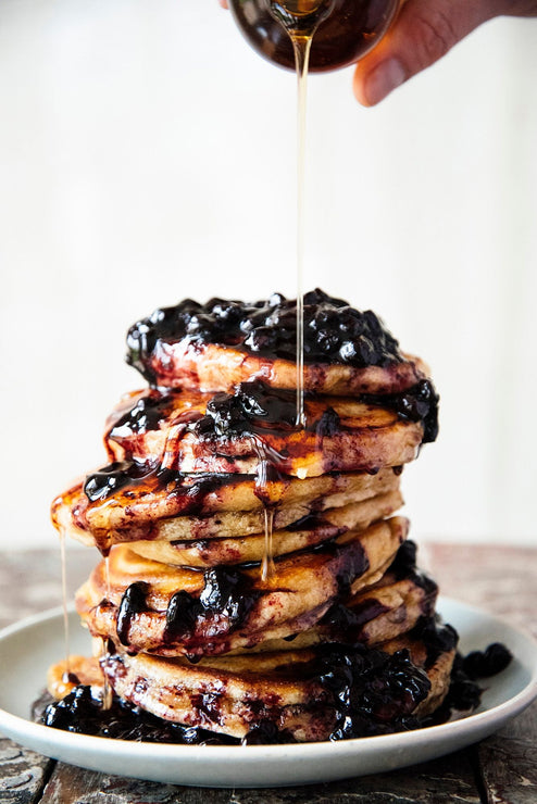 Load image into Gallery viewer, A large stack of pancakes topped with Fruit Perfect Blueberries and Maple Syrup drizzled on top
