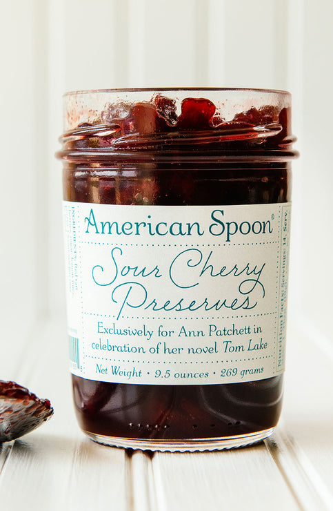 Load image into Gallery viewer, a jar of special edition sour cherry preserves made exclusively for annm patchett in celebration of her novel tom lake
