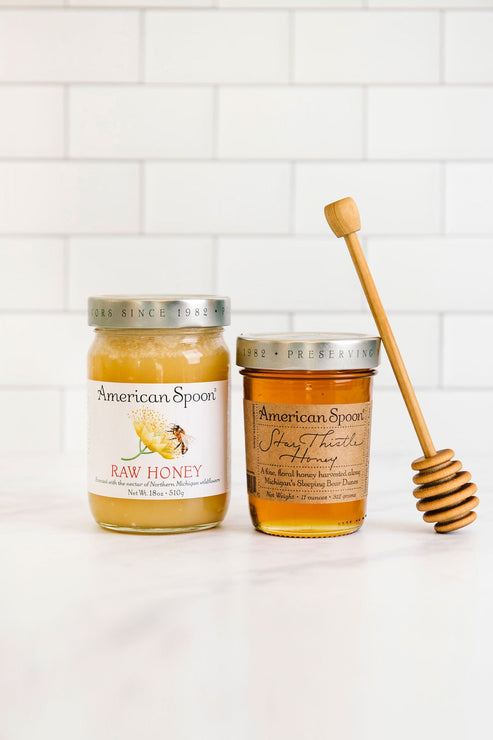 Load image into Gallery viewer, A jar of Raw Honey and Star Thistly Honey, with a honey dipper leaning against one jar
