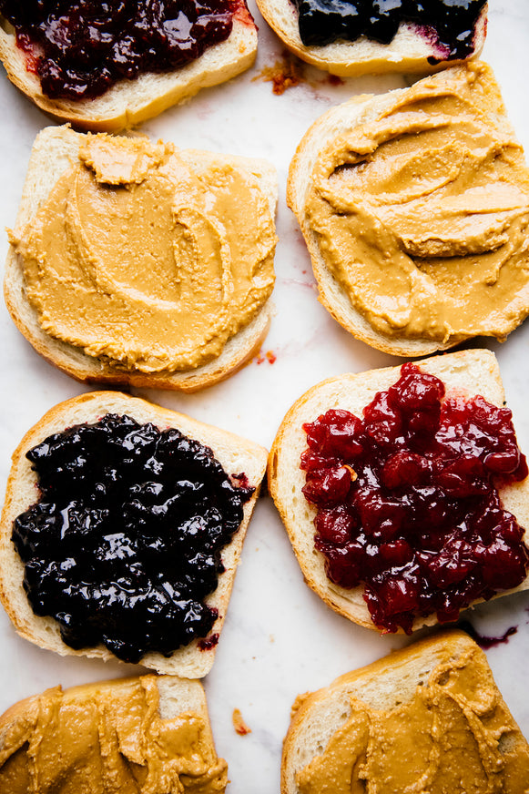 Slices of toast topped with Peanut Butter and preserves
