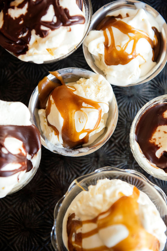 Cups of ice cream topped with Salted Maple Caramel and Chocolate Fudge Sauce