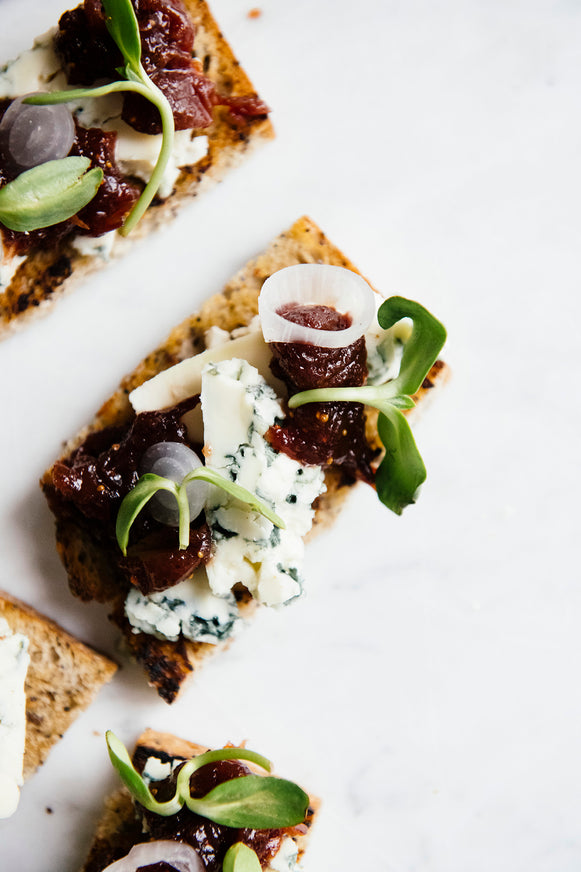 Crackers topped with blue cheese, goat cheese and preserves