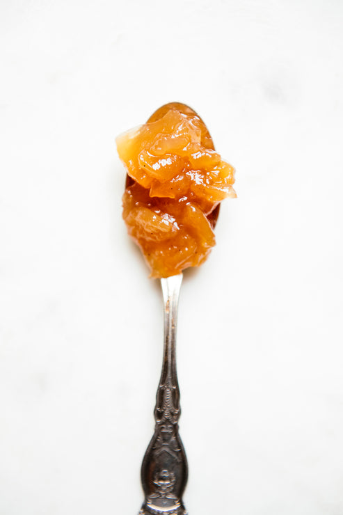 Load image into Gallery viewer, A spoon full of Red Haven Peach Preserves
