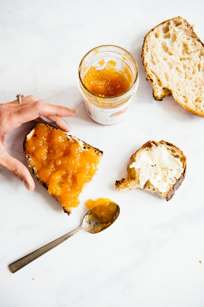 Slices of toast topped with butter and preserves