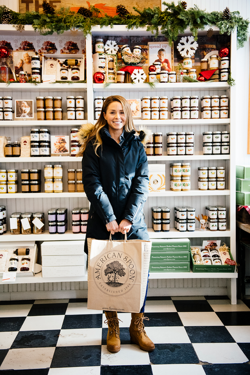 Load image into Gallery viewer, A customer standing in front of stocked shelves at the American Spoon store in Petoskey
