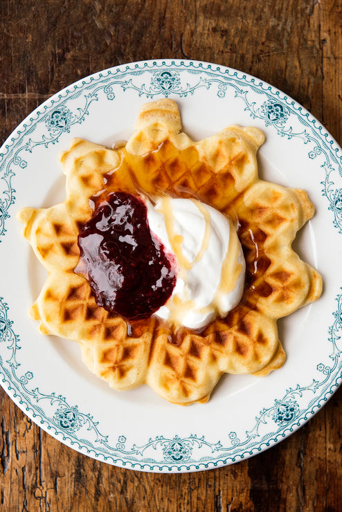 Load image into Gallery viewer, A waffle topped with whipped cream and preserves

