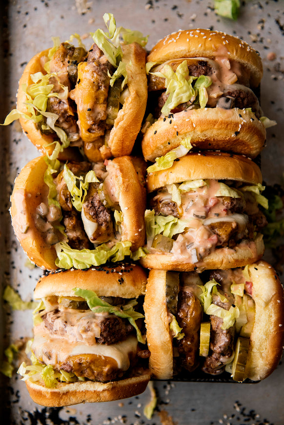 Burgers topped with lettuce and pickles