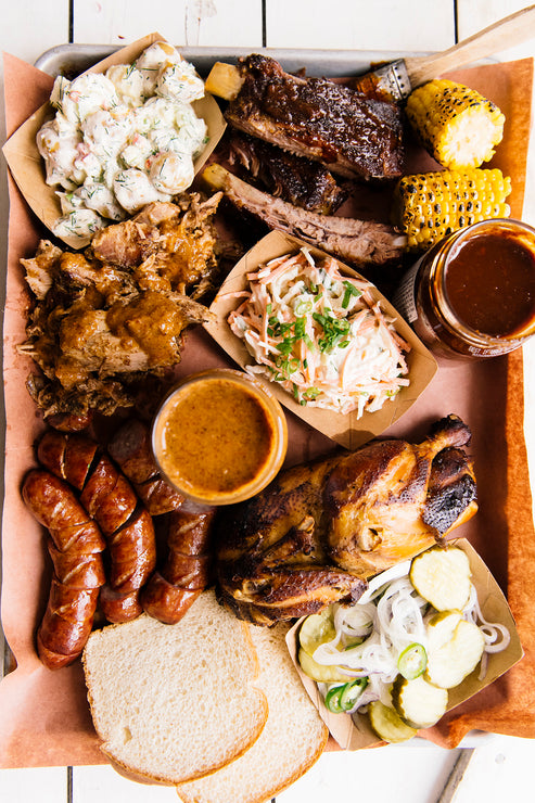 Load image into Gallery viewer, A tray of barbecue and bratwurst made with American Spoon Grilling Sauces 
