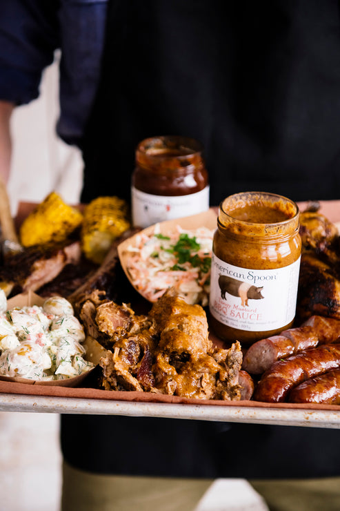 Load image into Gallery viewer, A tray of barbecue and bratwurst made with American Spoon Grilling Sauces 
