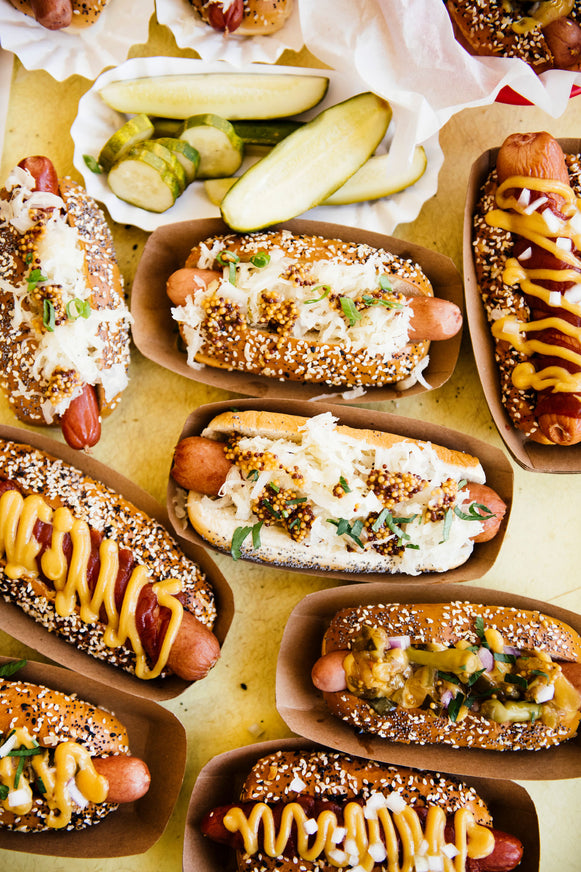 Hot dogs topped with sauerkraut, mustard, House Ketchup and Wholeseed Mustard