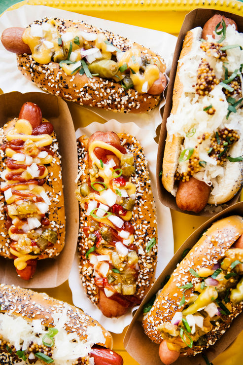 Load image into Gallery viewer, Hot Dogs topped with House Ketchup, Wholeseed Mustard, sauerkraut and onions
