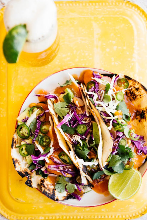 Load image into Gallery viewer, A plate of fish tacos topped with House Hot Sauce
