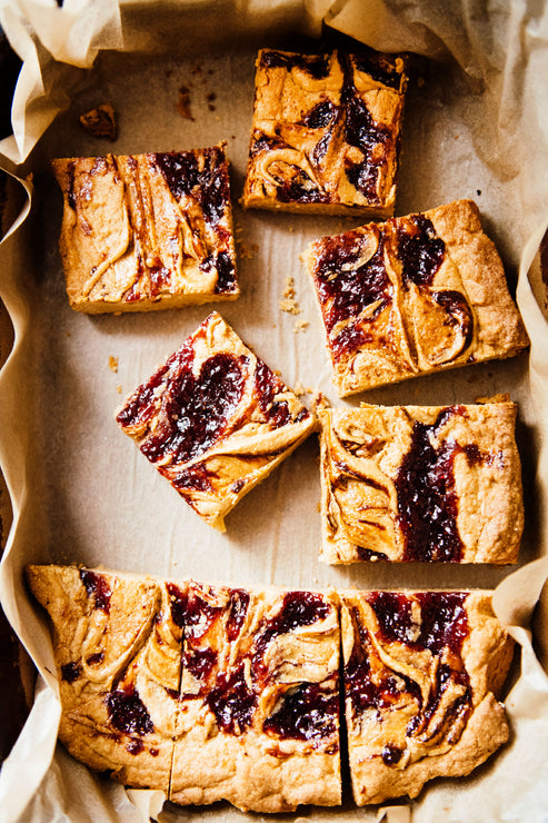 Load image into Gallery viewer, A tray of Peanut Butter and preserve blondies
