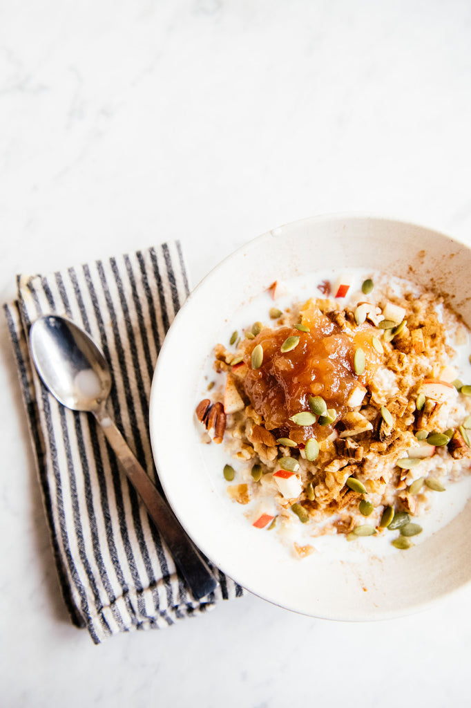 A bowl of yogurt topped with muesli and Apple Butter