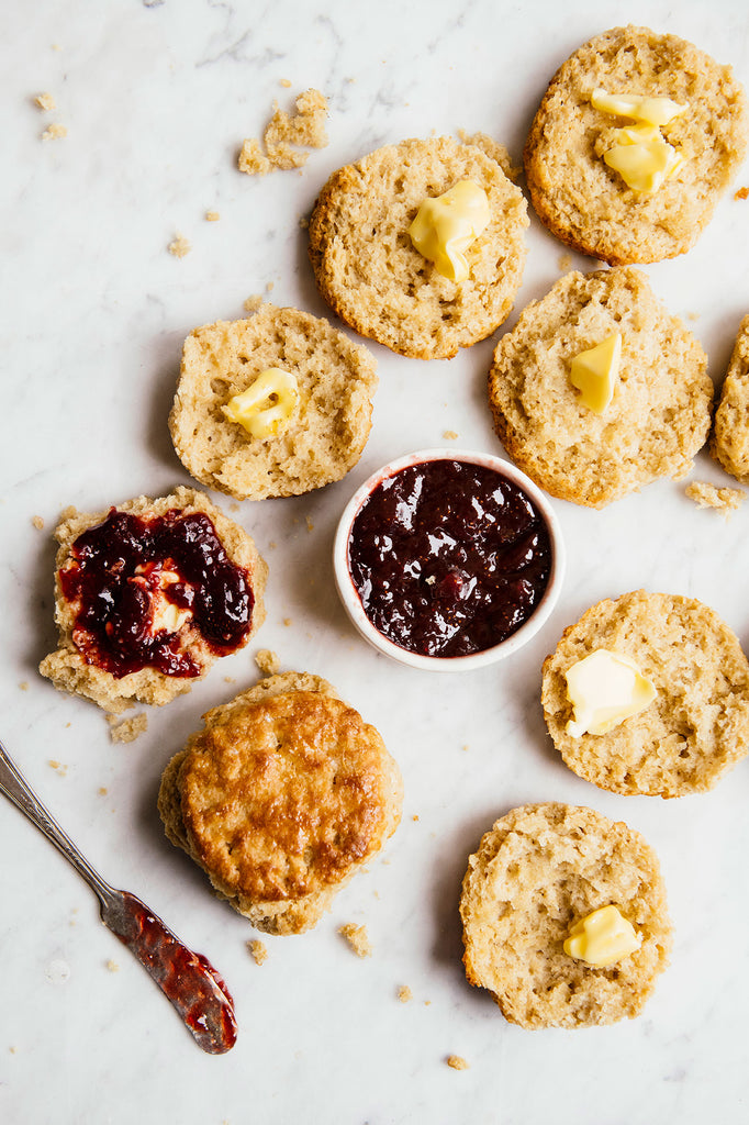 Open face homemade biscuits with preserves and melted butter